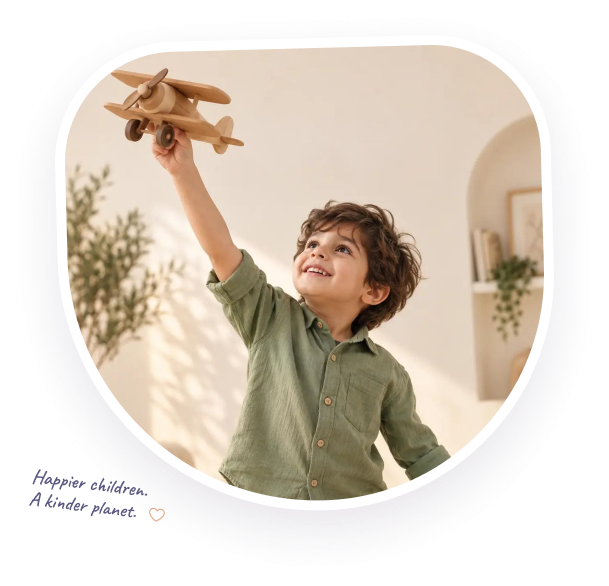 A child holding a wooden aeroplane toy joyfully